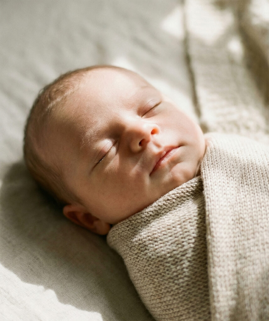 Schlafendes Baby während Mama im Wochenbett ist